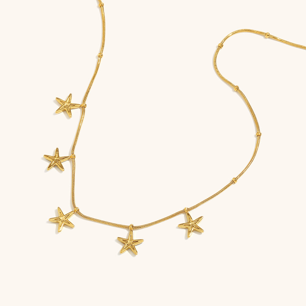 Close-up of star pendant necklace in silver and gold tones