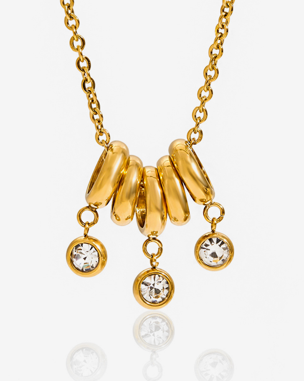 Gold necklace with circular pendants and crystal drops on a white background