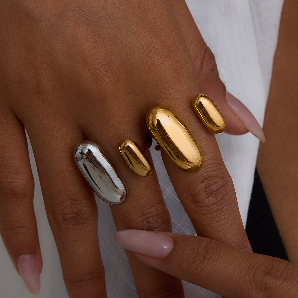 Fashionable woman styling mixed metal open rings, perfect for party or dinner wear