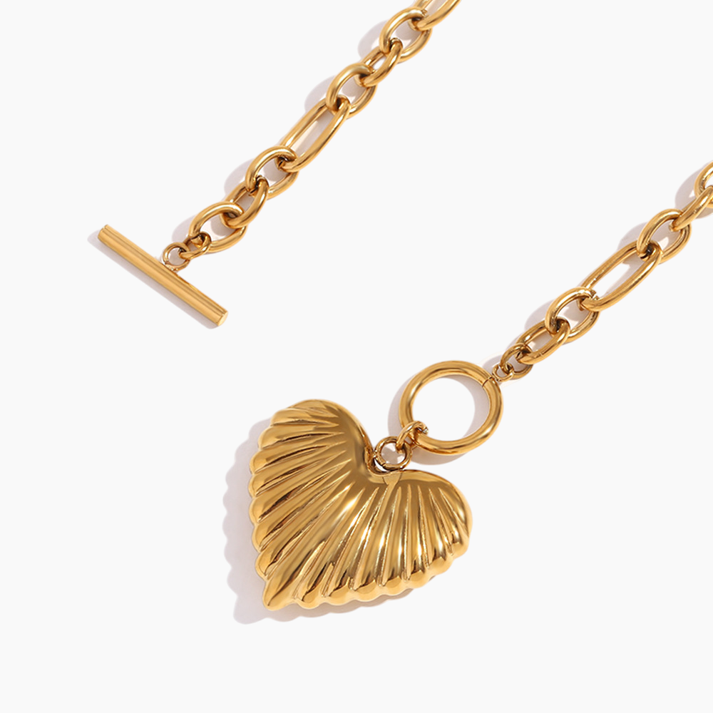 Gold chain necklace with a shell pendant on a white background