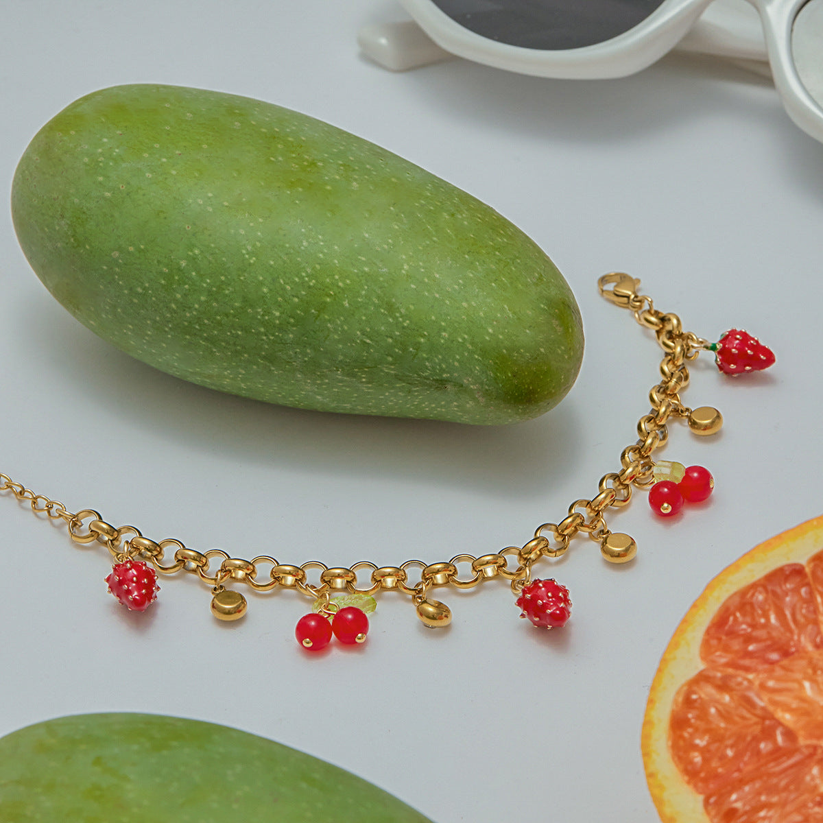 Product image of fruit charm bracelet with detailed enamel strawberries and cherry drops