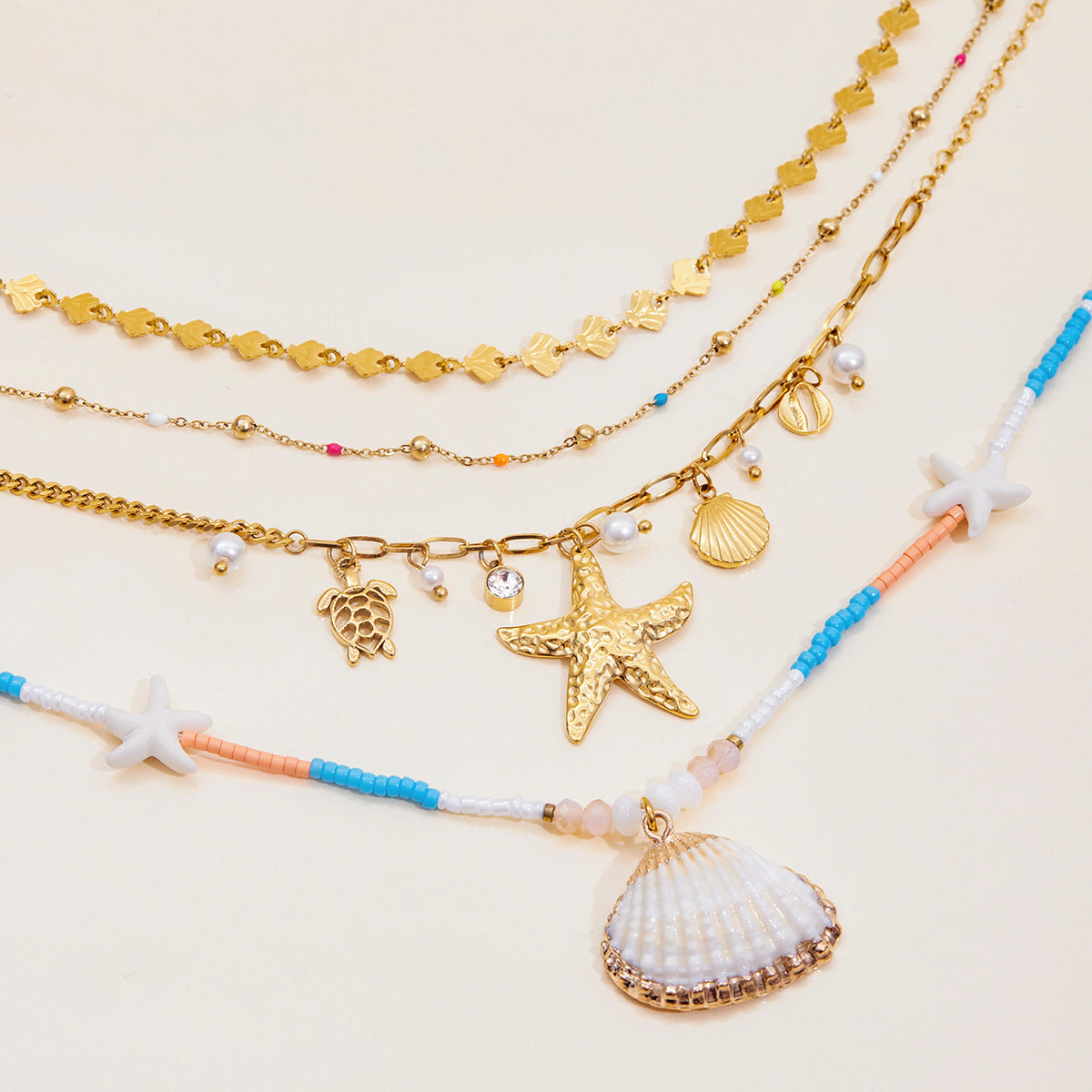 Close-up of white, blue and coral beaded necklace with seashell pendant