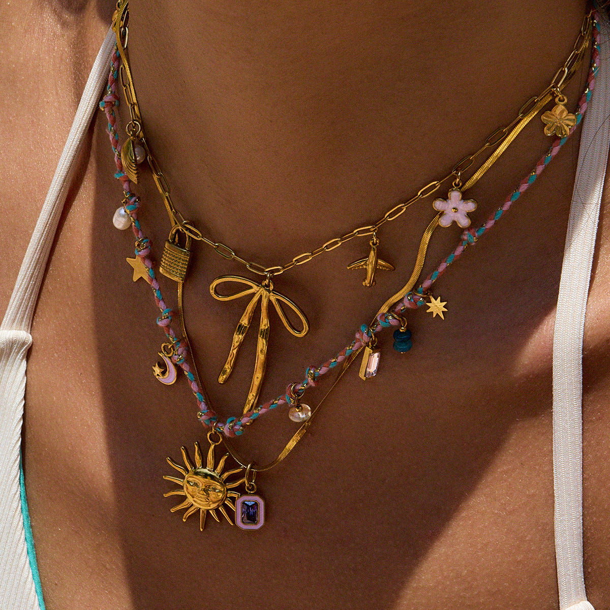 Close-up of waterproof charm necklace with stars and pearls