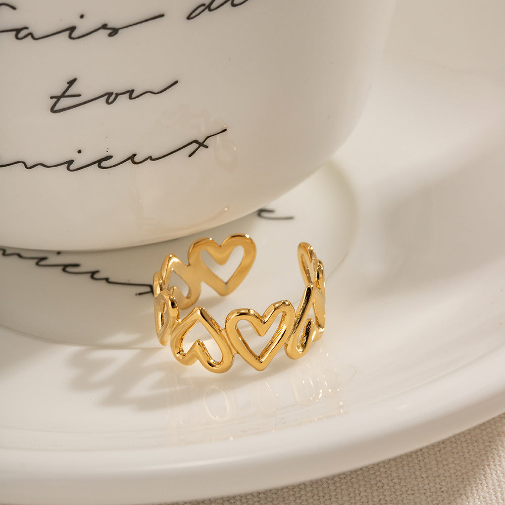 Gold stacking ring with wave design and CZ stones, model hand close-up.