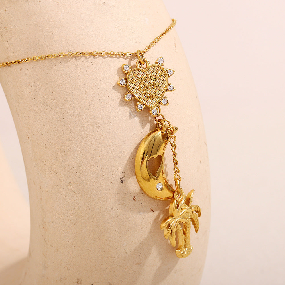 close-up of heart sun charm and hollow moon on gold necklace for women
