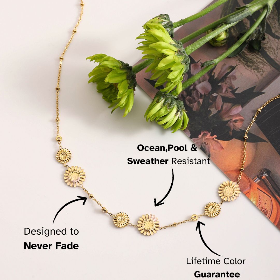 Gold daisy medallion necklace on floral magazine – weatherproof boho-inspired piece for everyday styling