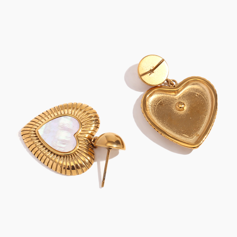 Gold heart-shaped earrings on a white background