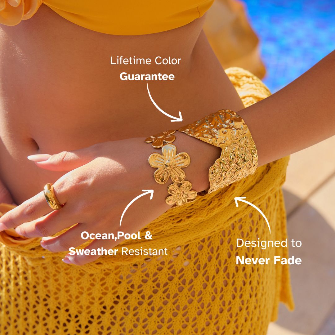 Layered floral and hammered gold cuff bracelets glowing in the sunlight