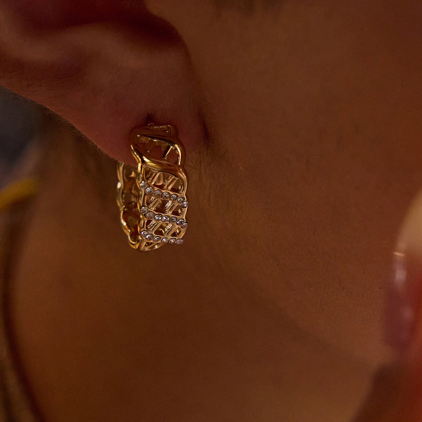 Gold and silver mixed hoop earrings shown on neutral display plate