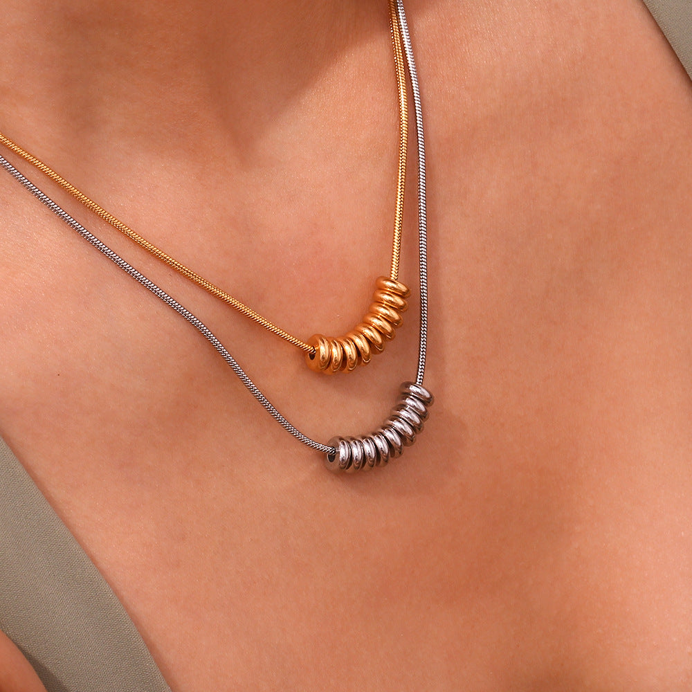 Flat-lay styling of bead bar necklace with summer dress and accessories