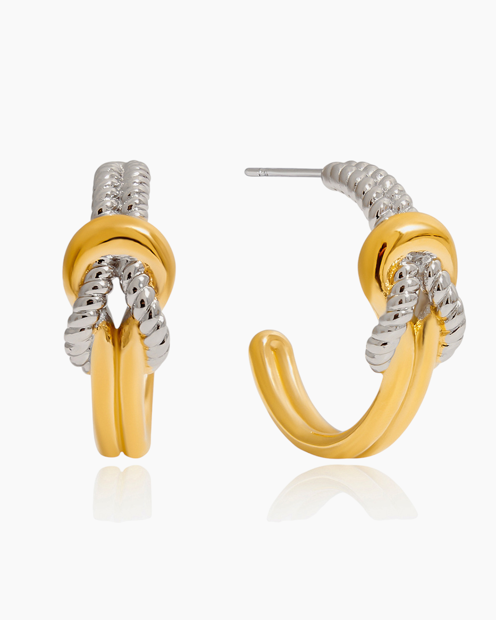 Gold and silver hoop earrings on a white background