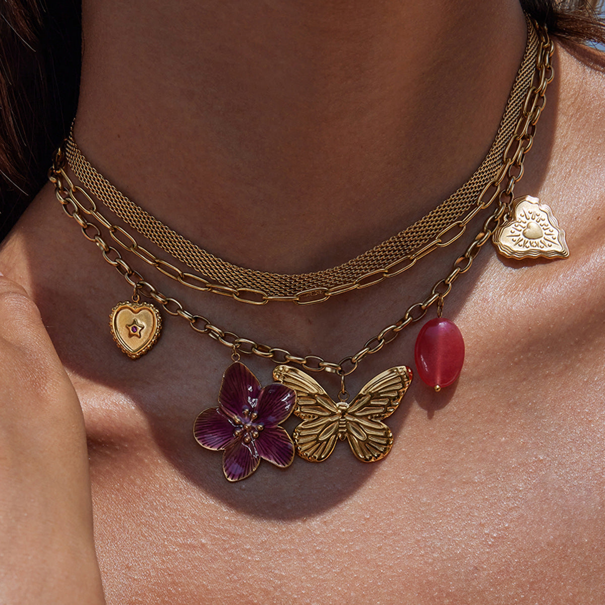 Summer jewelry necklace styled on tanned skin with golden glow