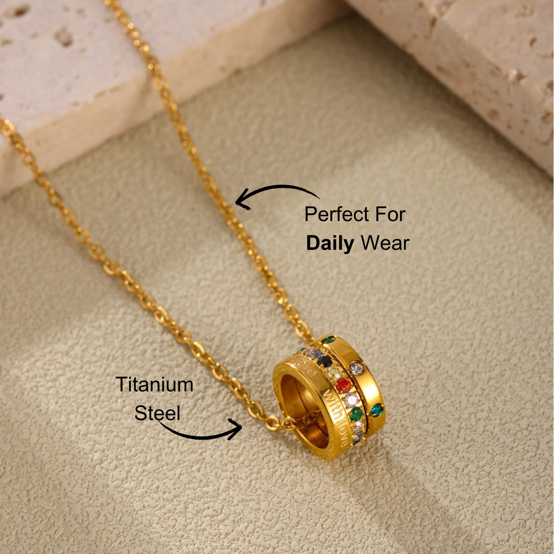 Stunning 'With Love' Triple Ring Necklace featuring multicolor zircon stones, set in stainless steel, styled with a layered chain design on a neutral background.