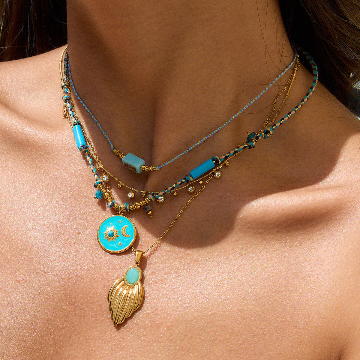 Layered beachwear necklace look with gold and turquoise pendants