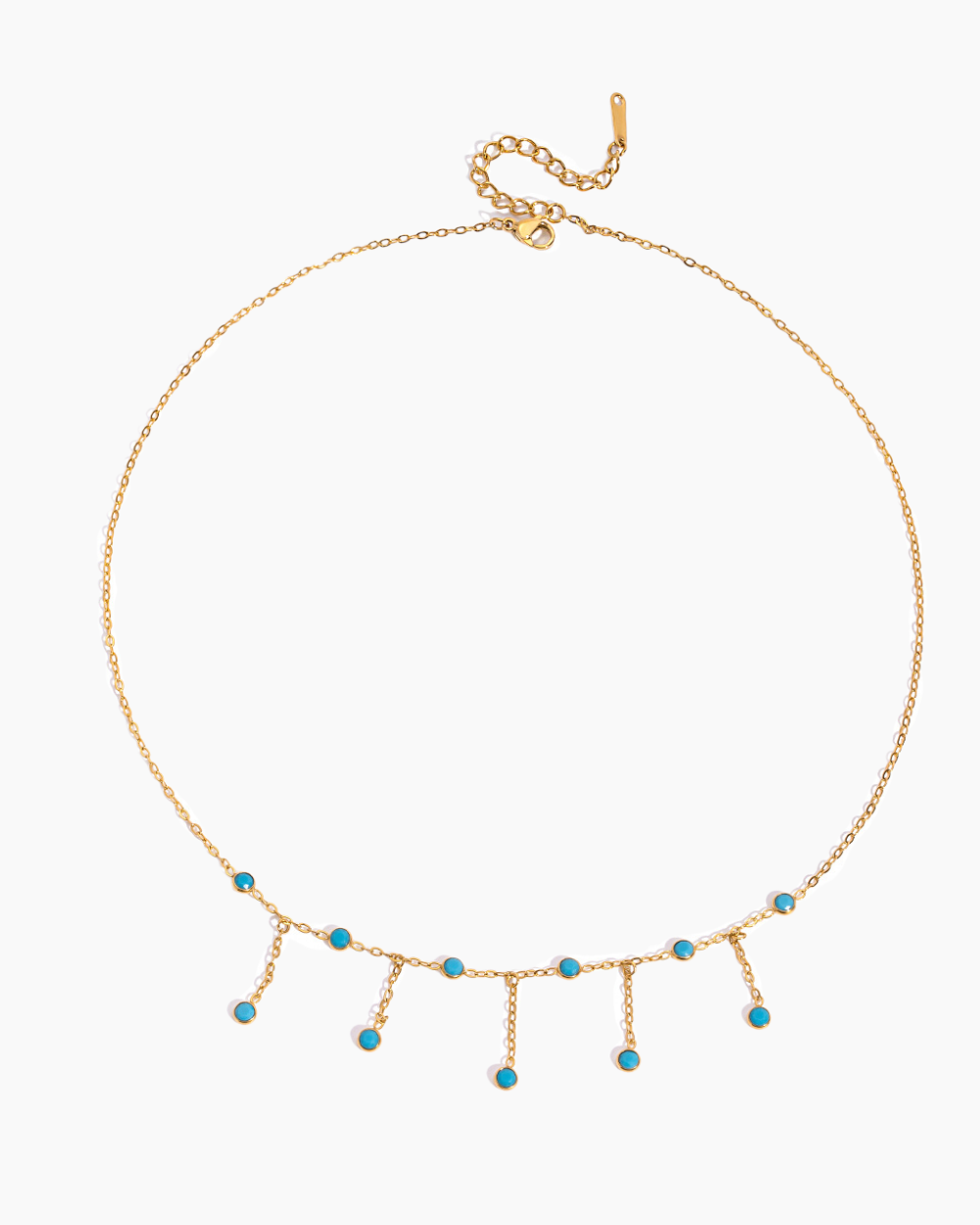 Gold necklace with turquoise beads on a white background