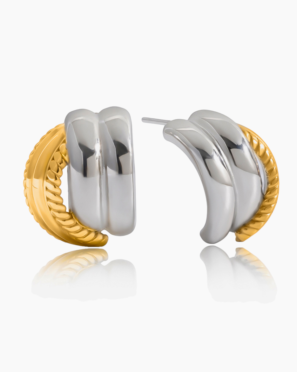 Pair of gold and silver hoop earrings on a white background