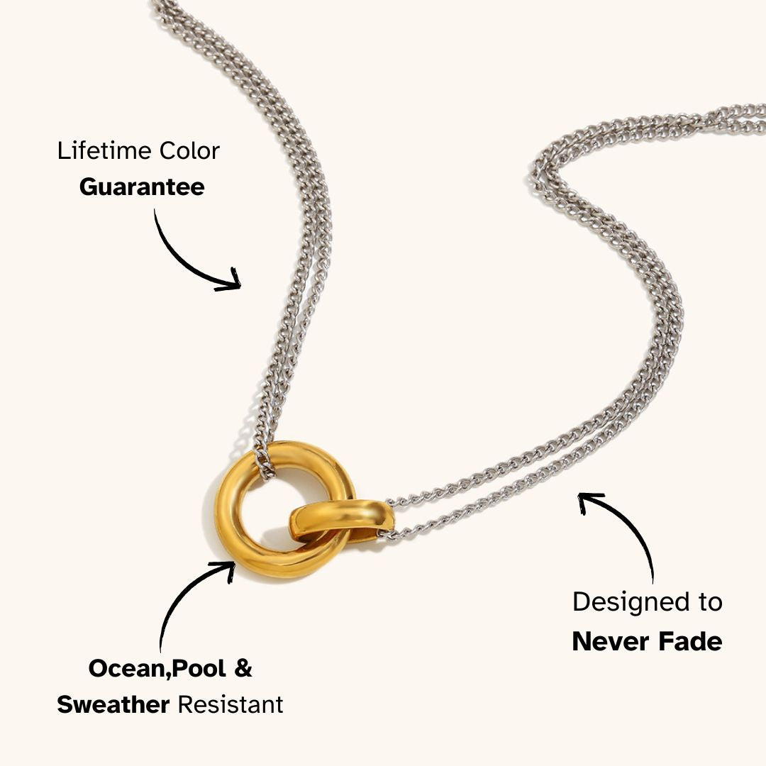 Silver and gold interlocking loop necklace, shown on light background