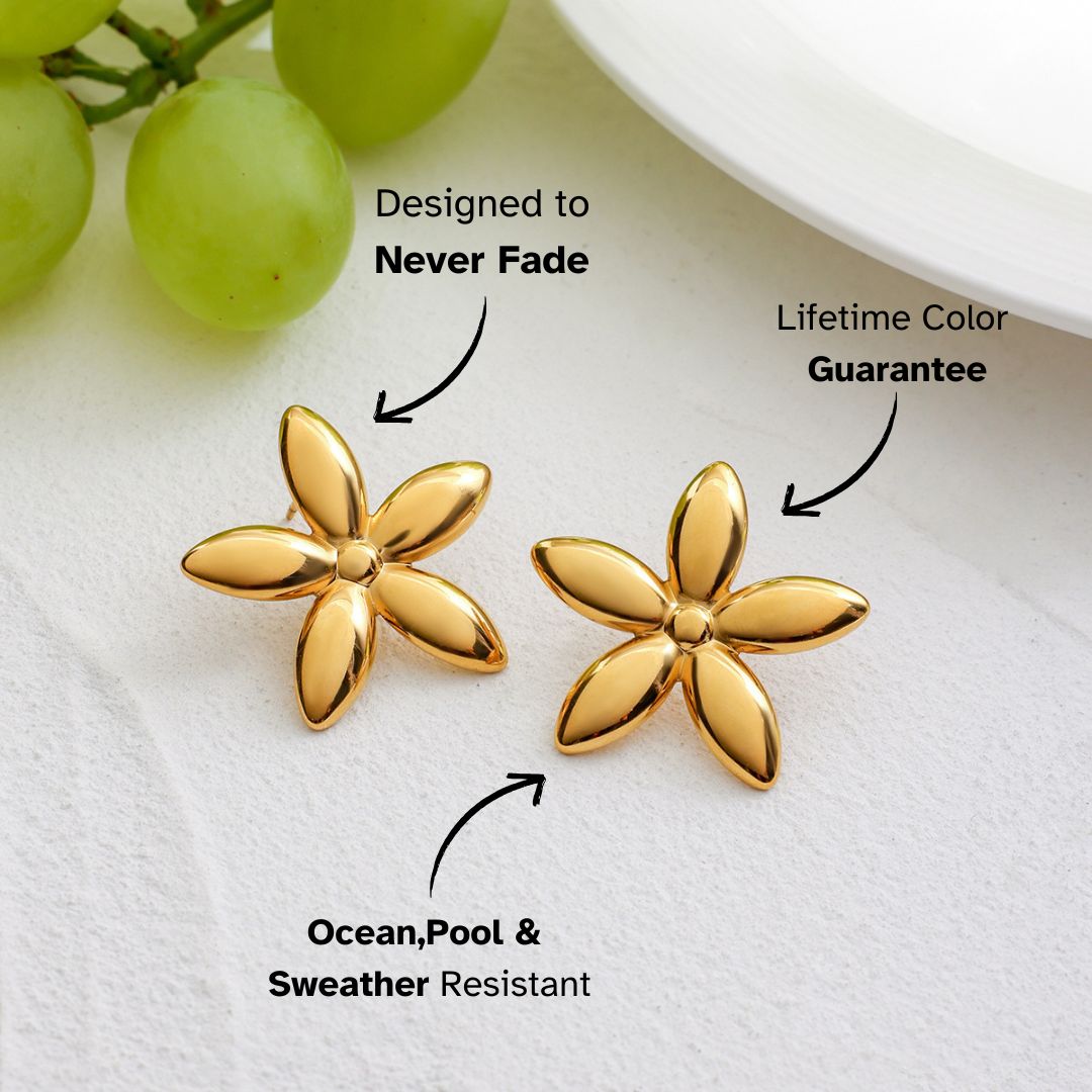 Statement flower studs styled on fruit plate with bright summer colors