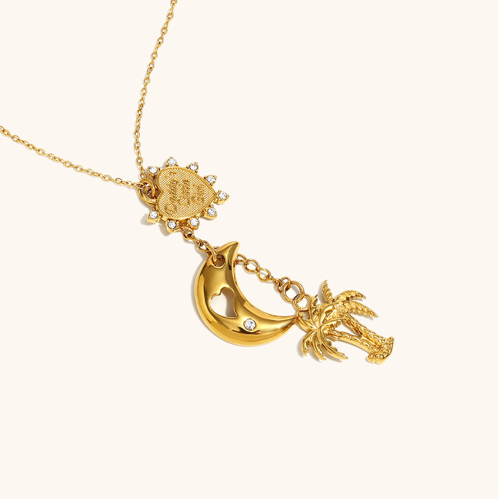summer-themed gold charm necklace with palm tree, moon and sun accents