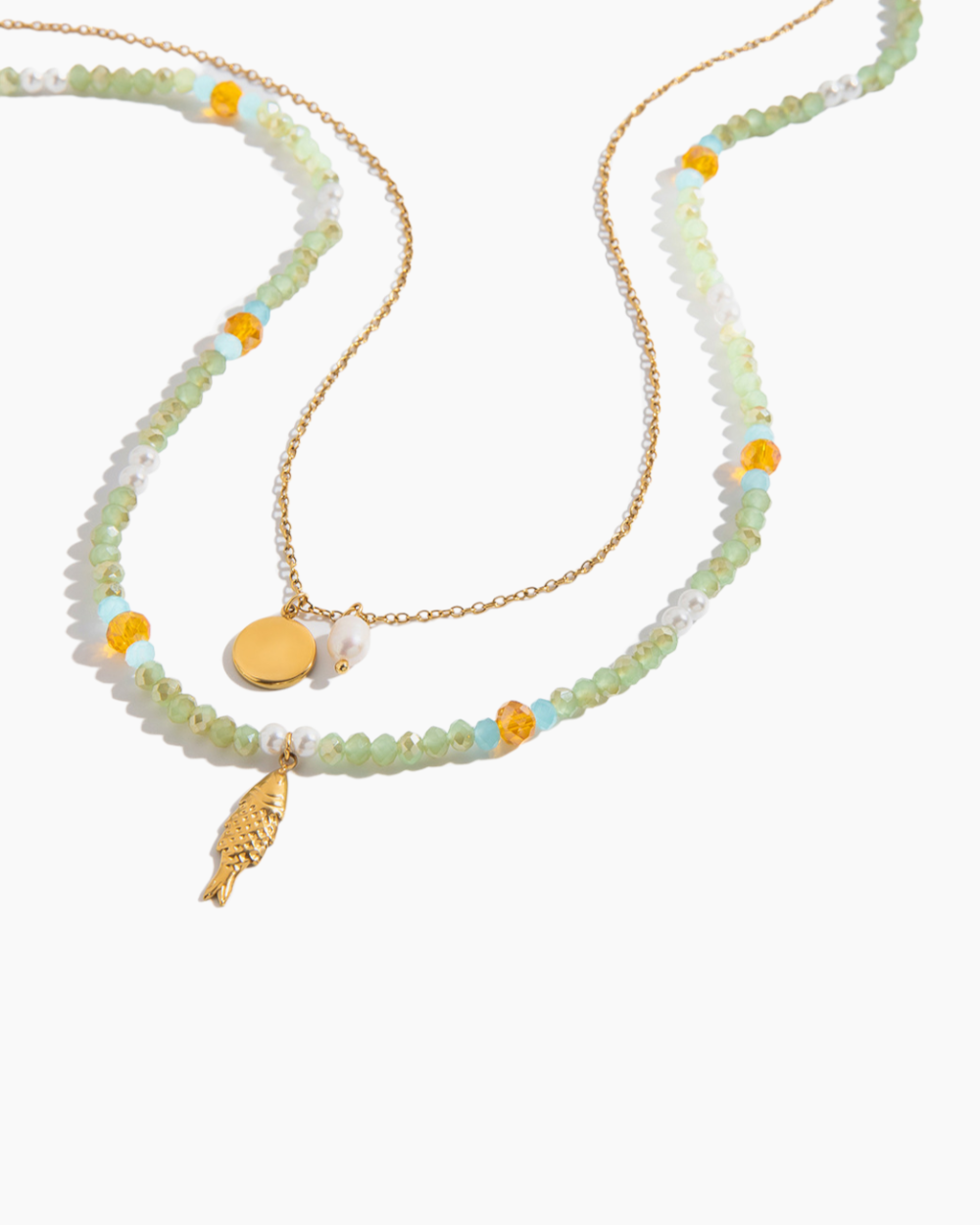 Beaded necklace with gold pendants on a white background
