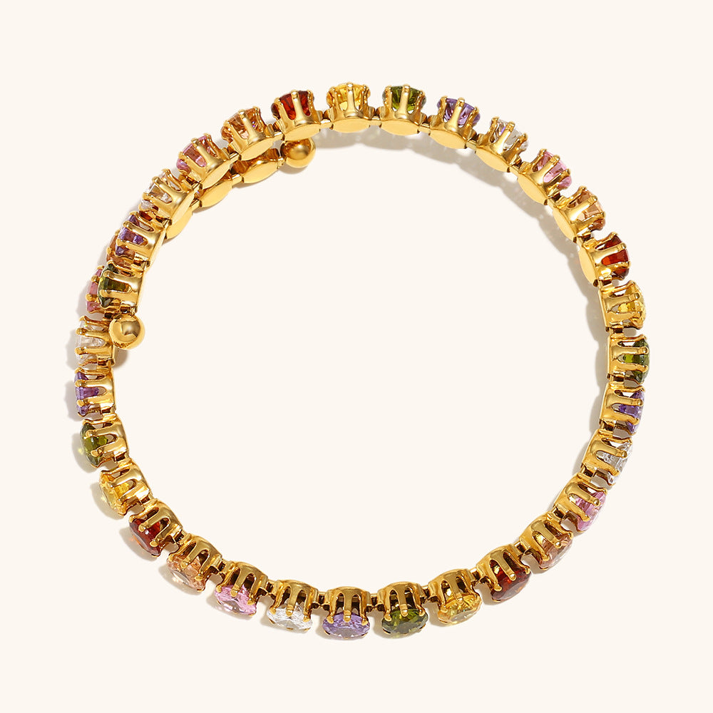 Round cut multicolor stones gold bracelet shown on neutral background