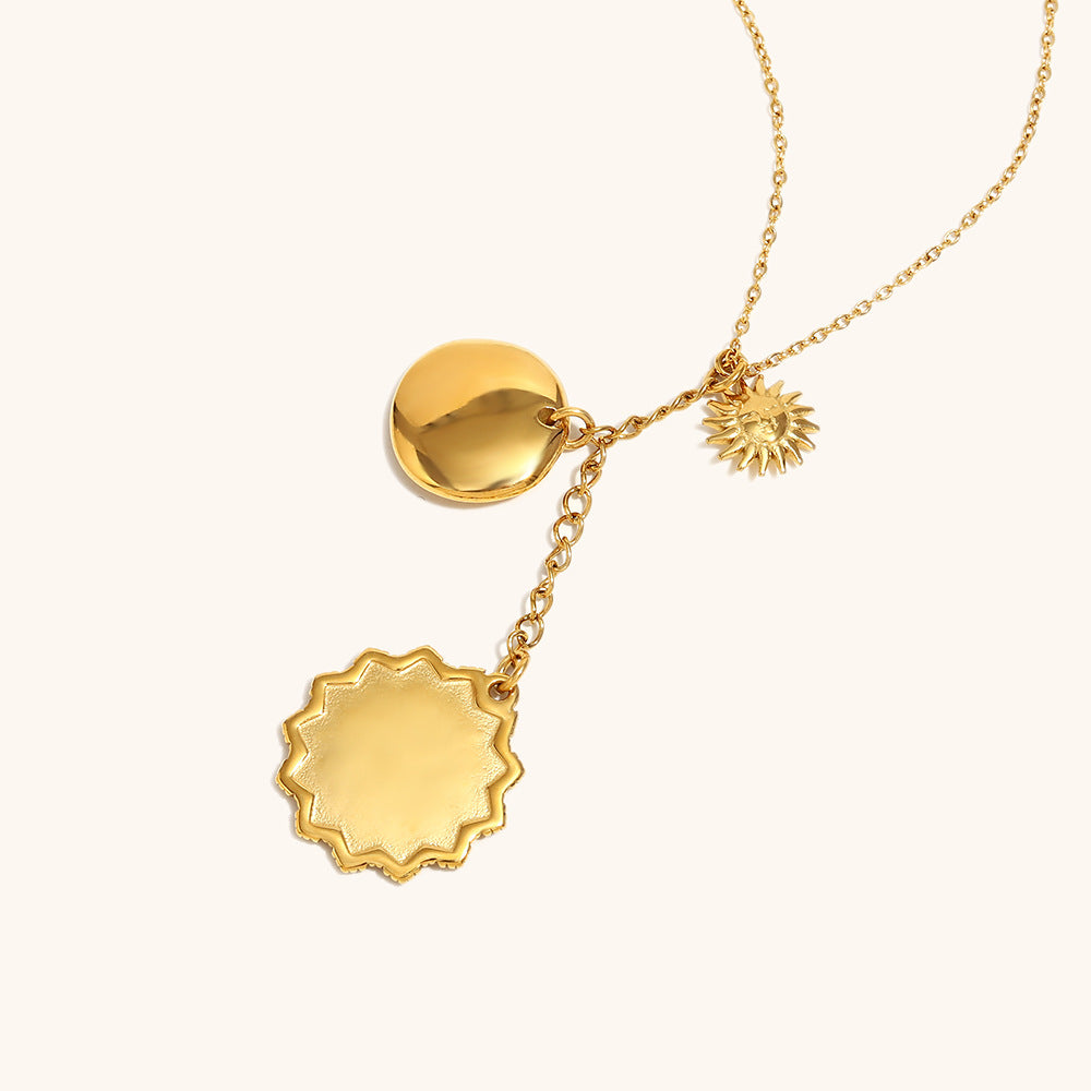 Close-up of layered gold coin charms featuring engraved symbols
