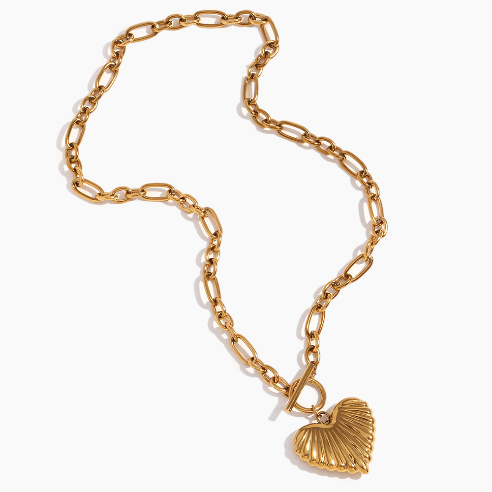 Gold chain bracelet with a shell charm on a white background