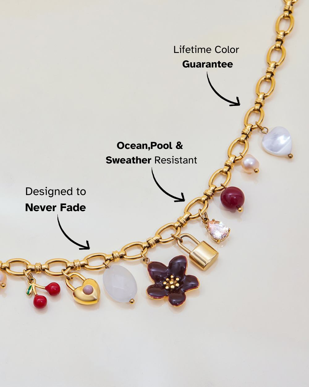 Gold necklace with various charms on a light background