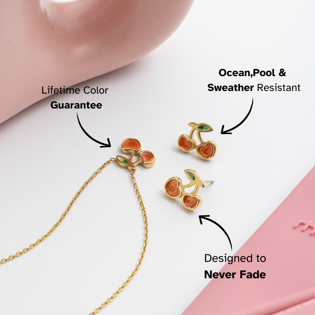 Cherry-themed jewelry set with gold chain and earrings on a white background, featuring text about product features.