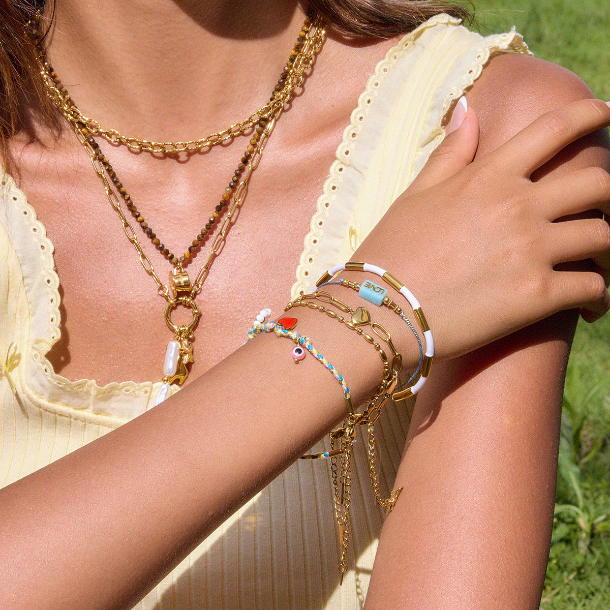 Close-up of multicolor bracelet with gold Mickey-shaped pendant