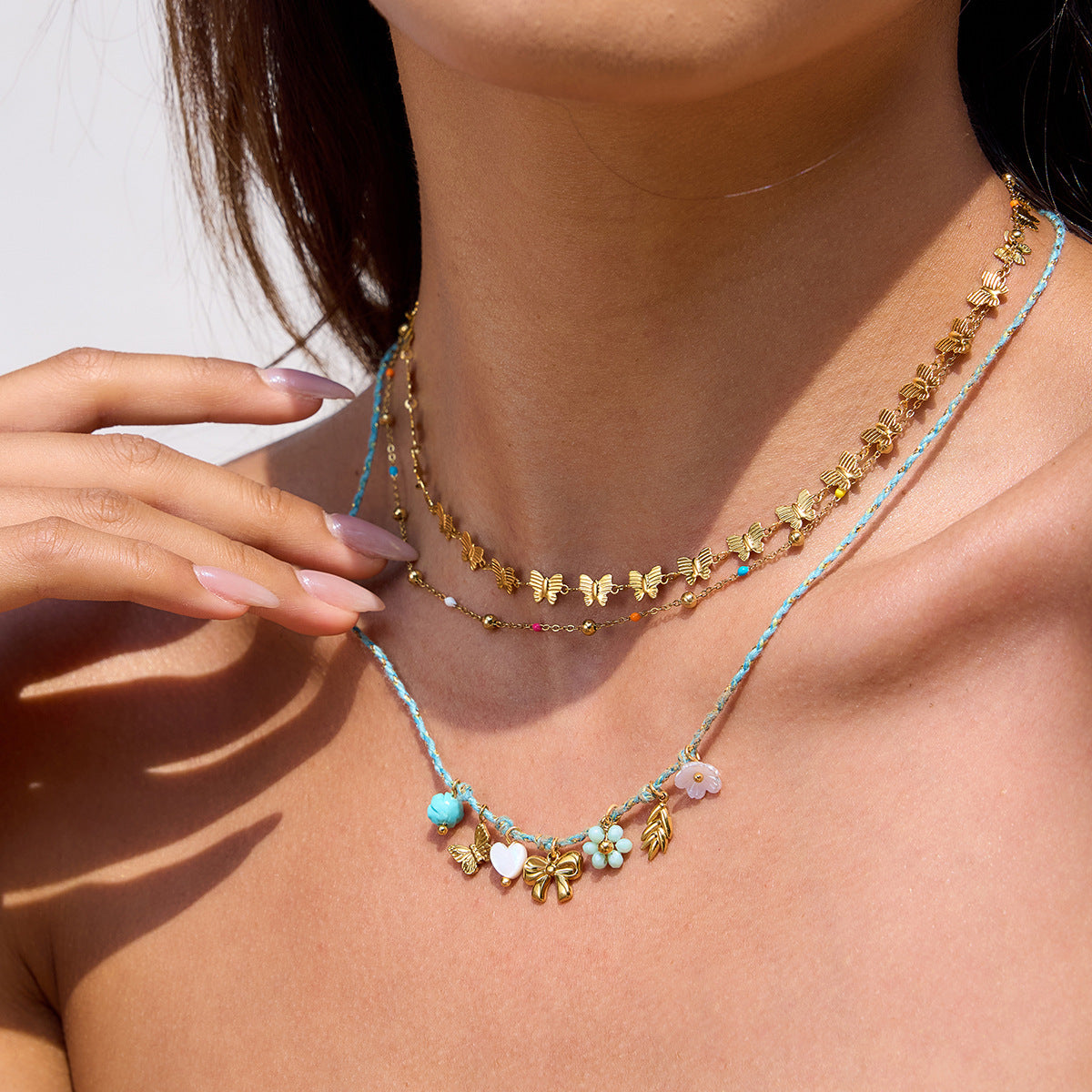 Woman wearing waterproof gold butterfly necklace under sunlight