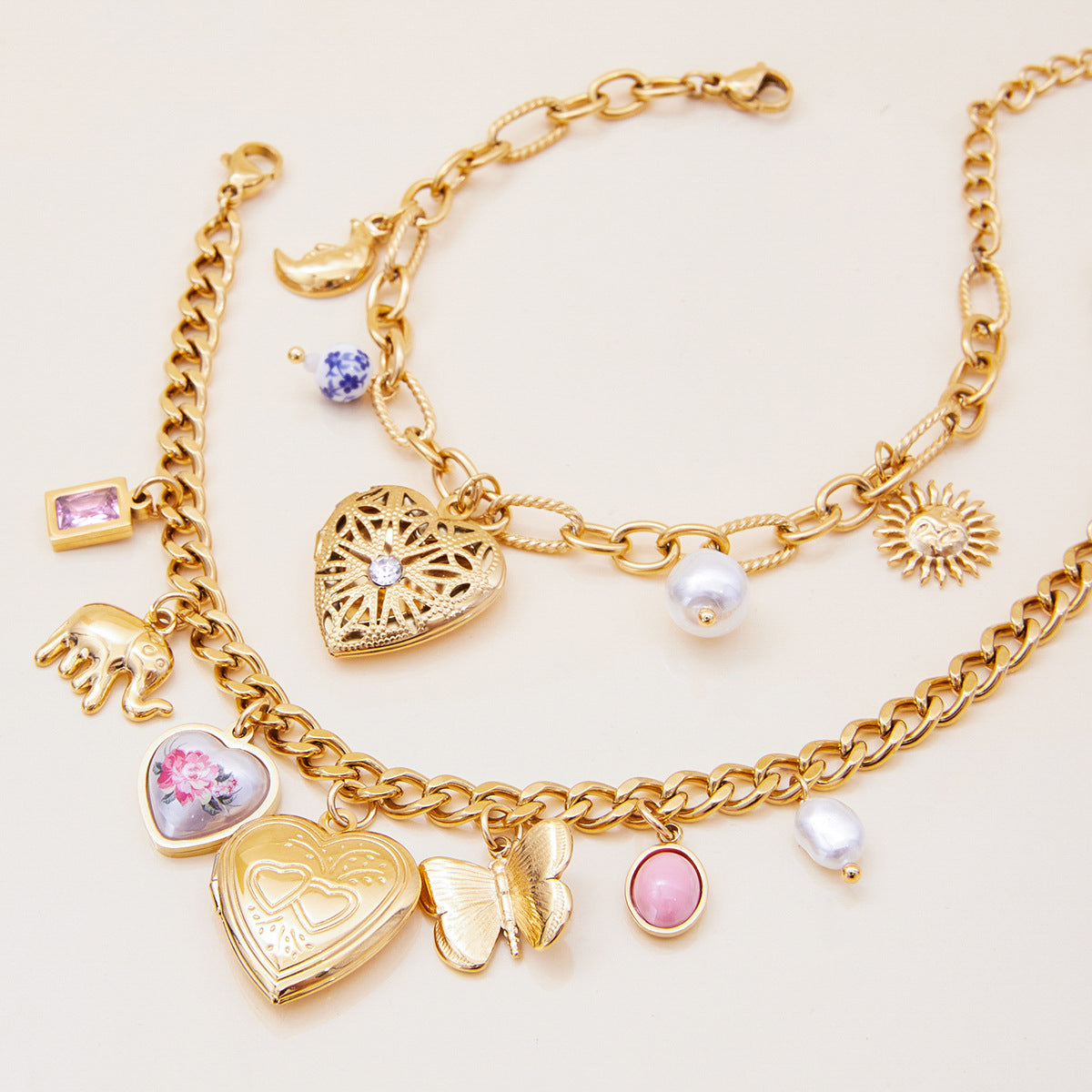 Vintage-style gold bracelet with flower locket and pearl charms