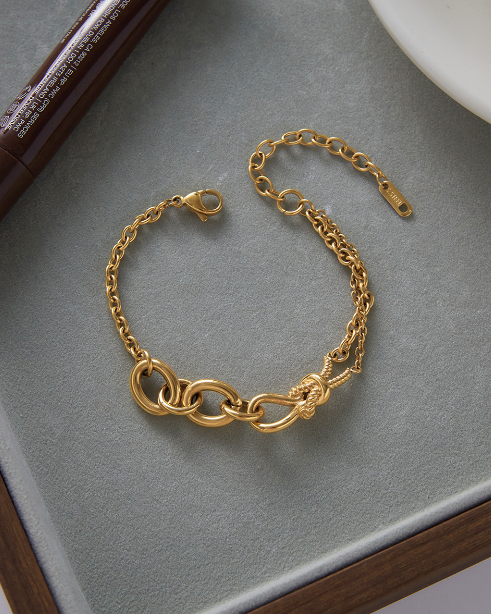 Gold bracelet on a gray surface
