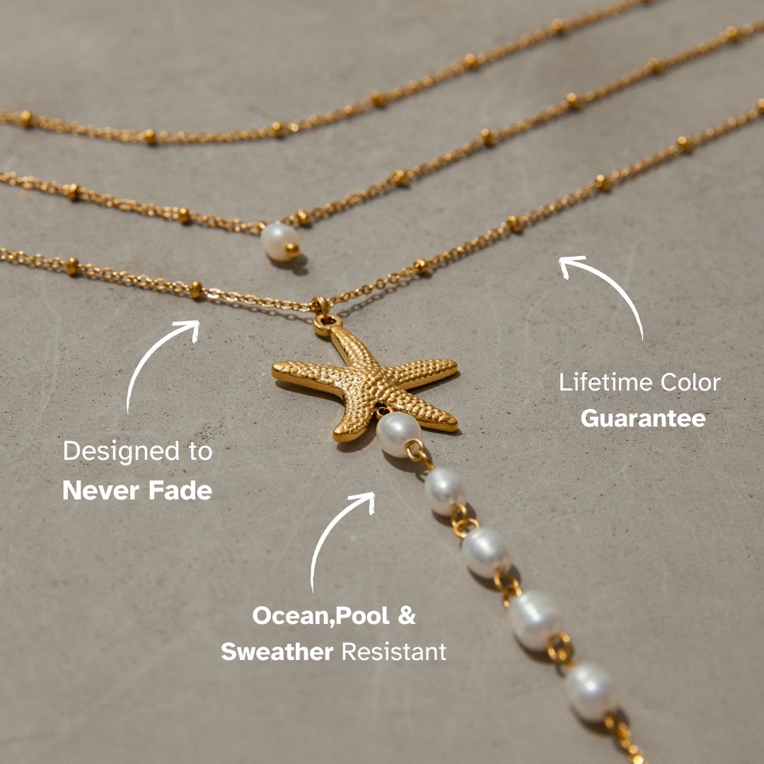 Zoomed view of pearl chain dropping from starfish charm against skin