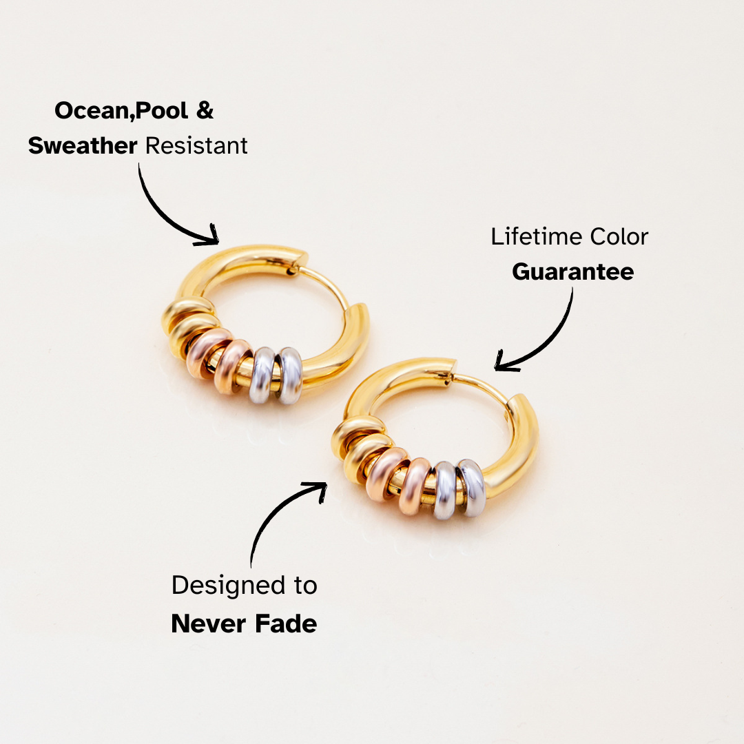 Gold hoop earrings with silver, rose gold, and gold rings