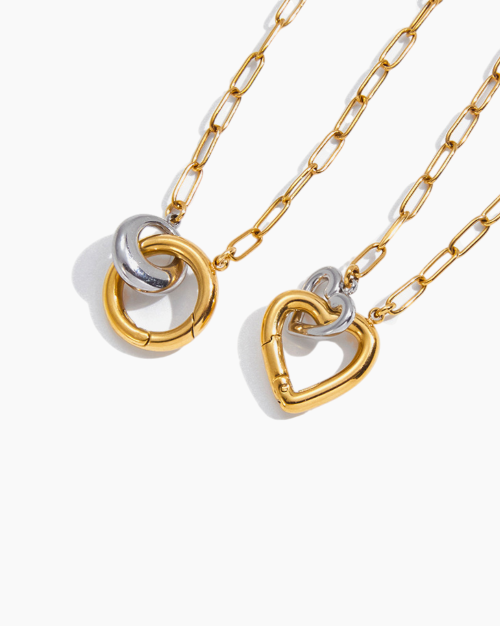 Gold and silver necklaces with interlocking heart pendants on a white background