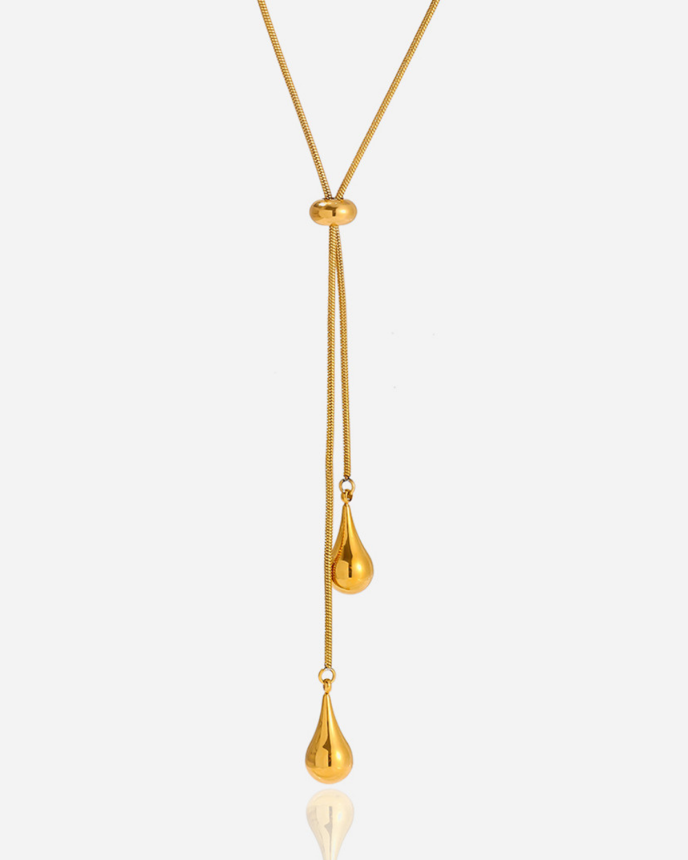 Gold necklace with a teardrop pendant on a white background