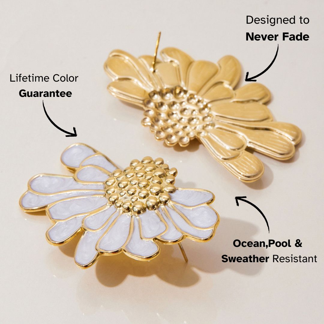 Side view of gold and white floral earrings with shiny petal texture