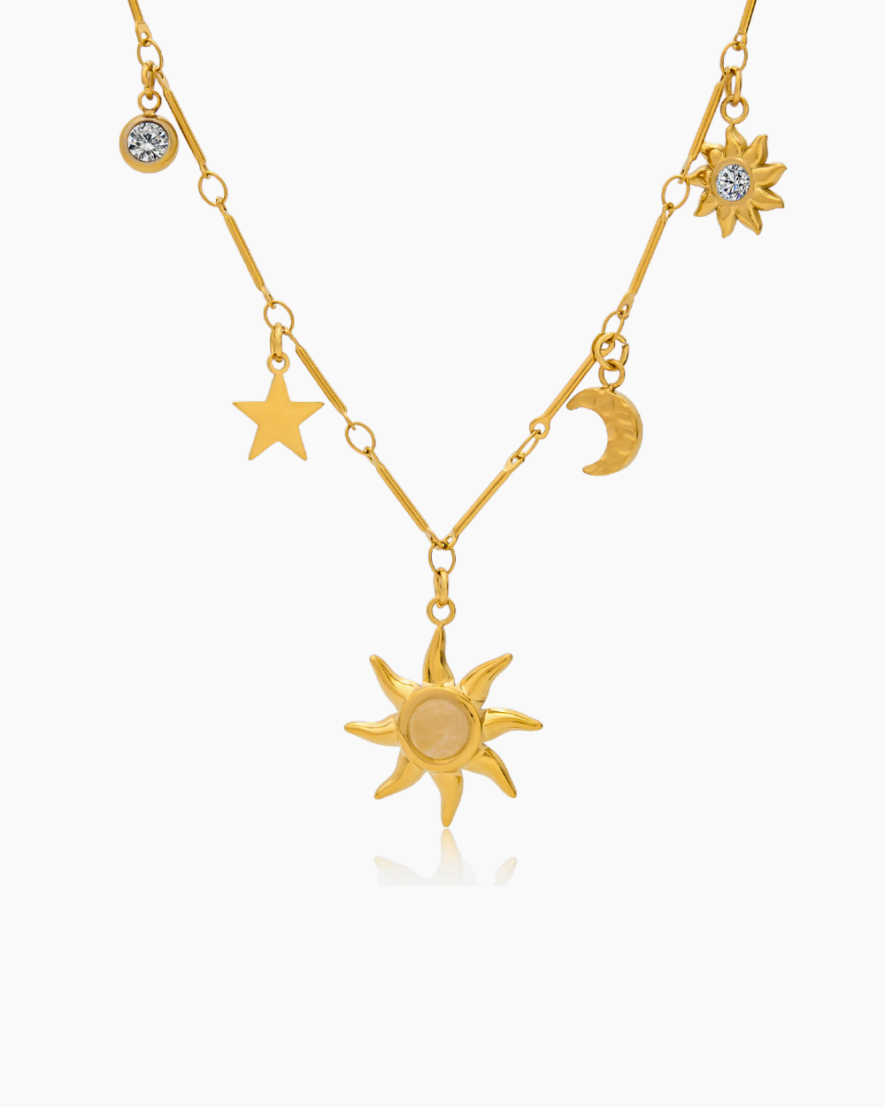 Gold necklace with sun, moon, and star pendants on a white background