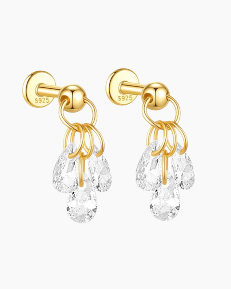 Gold earrings with clear teardrop-shaped stones on a white background