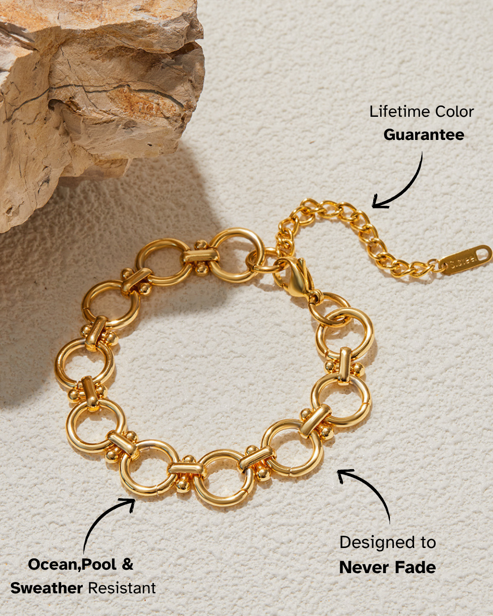 Gold chain bracelet on a textured surface with promotional text about color guarantee and durability.