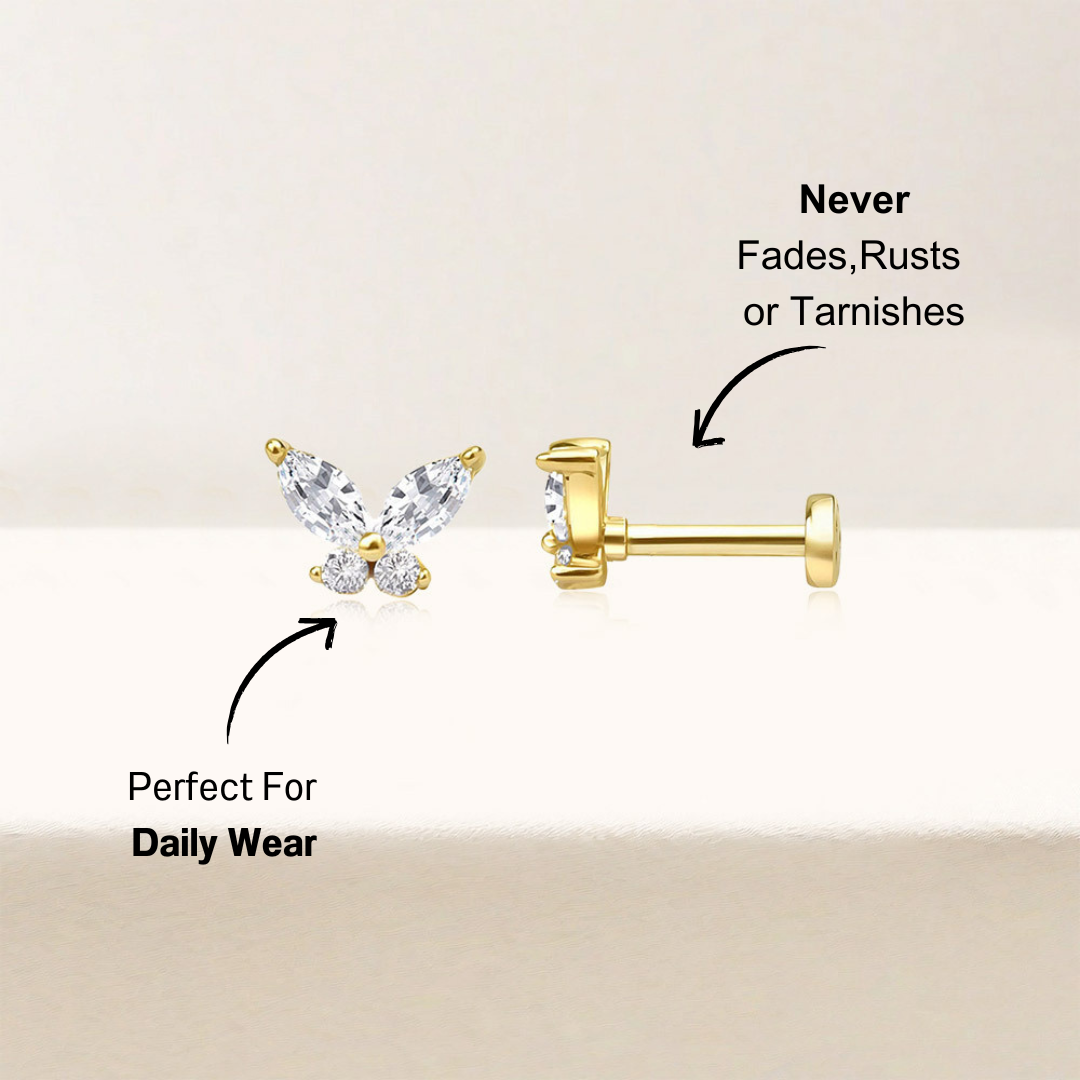 14K gold butterfly-shaped zirconia stud earrings shown against a soft, neutral background. The earrings are highlighted with shimmering white zirconia stones, creating a refined and elegant look.
