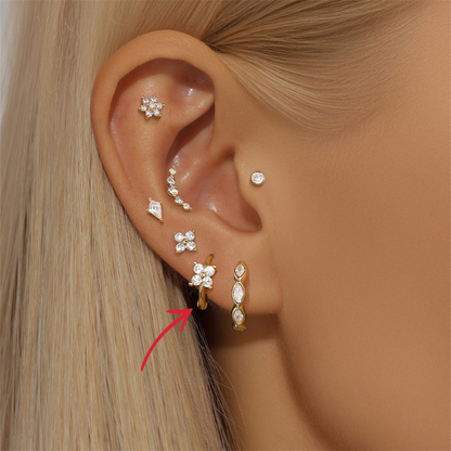 14K gold CZ clover hoop earrings paired with other sparkling jewelry, creating a chic and trendy look