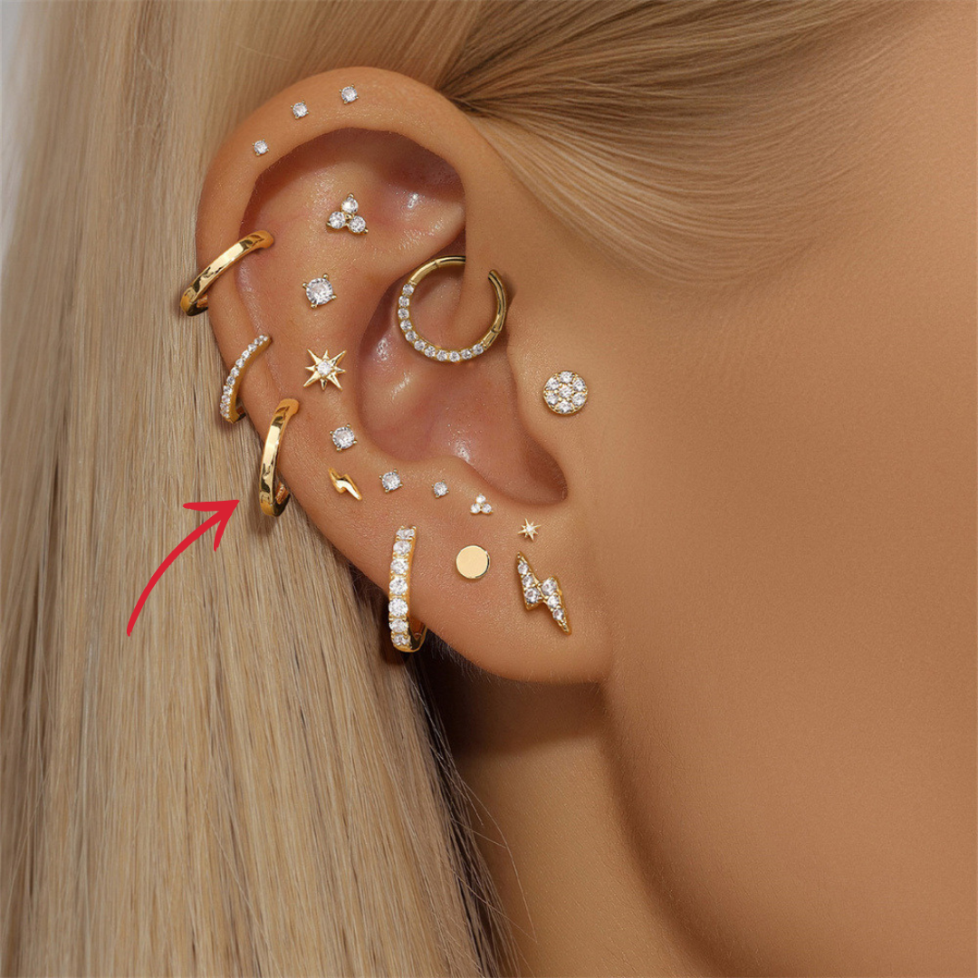 14K gold hoop earrings with a sleek, minimalist design, paired with other trendy jewelry for a chic style