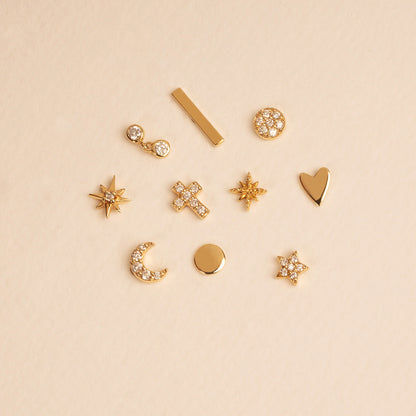 A collection of 14K gold earrings featuring stars, crosses, moons, and minimalist designs.