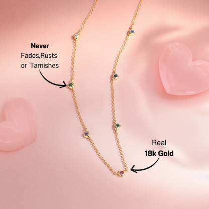 14k-gold-gemstone-necklace-pink-background.png – Stylish 14k gold necklace adorned with colorful gemstones displayed on a soft pink background, ideal for everyday wear and gifting.