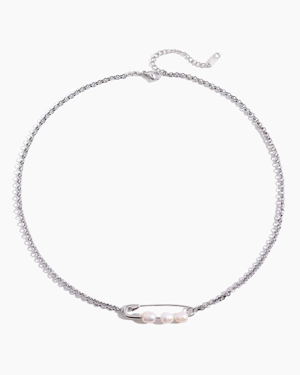 Silver necklace with a small pearl pendant on a white background