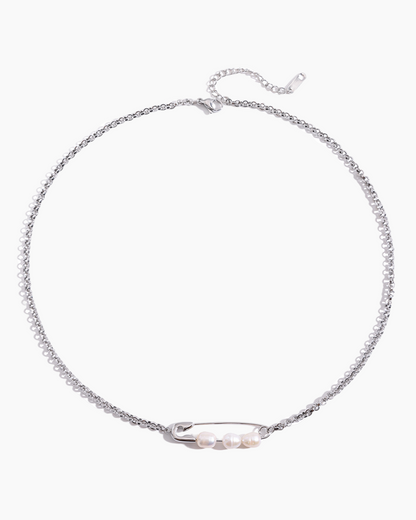 Silver necklace with a small pearl pendant on a white background