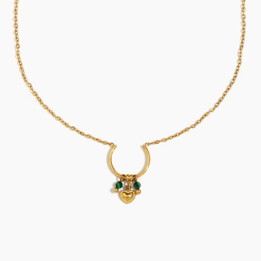 Gold necklace with a heart-shaped pendant on a white background