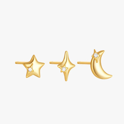 A set of three gold-plated stud earrings featuring a star, a sparkling starburst, and a crescent moon design with tiny gemstones.